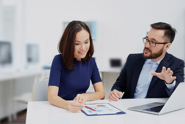 Two people discuss a chart