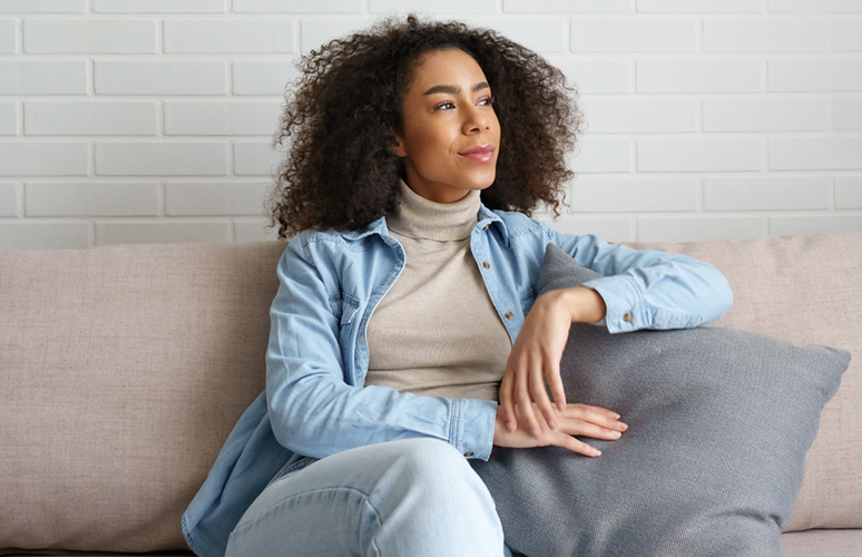 Woman smiles slightly looking away from camera