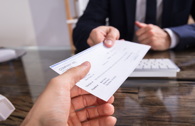 Person handing a check to another person