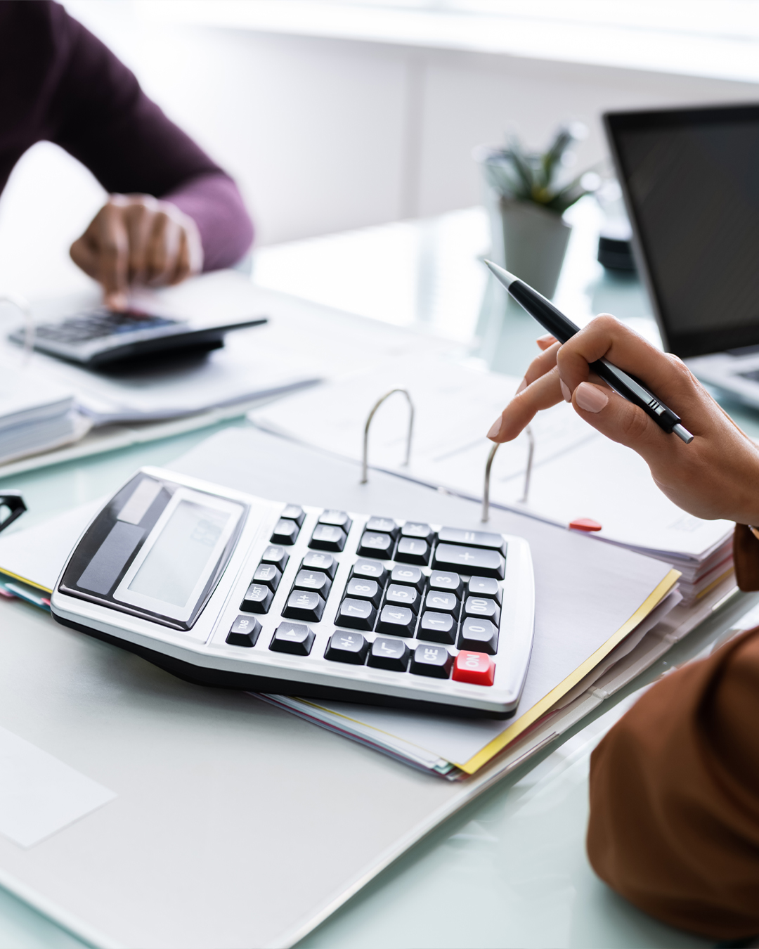 Two people using calculators