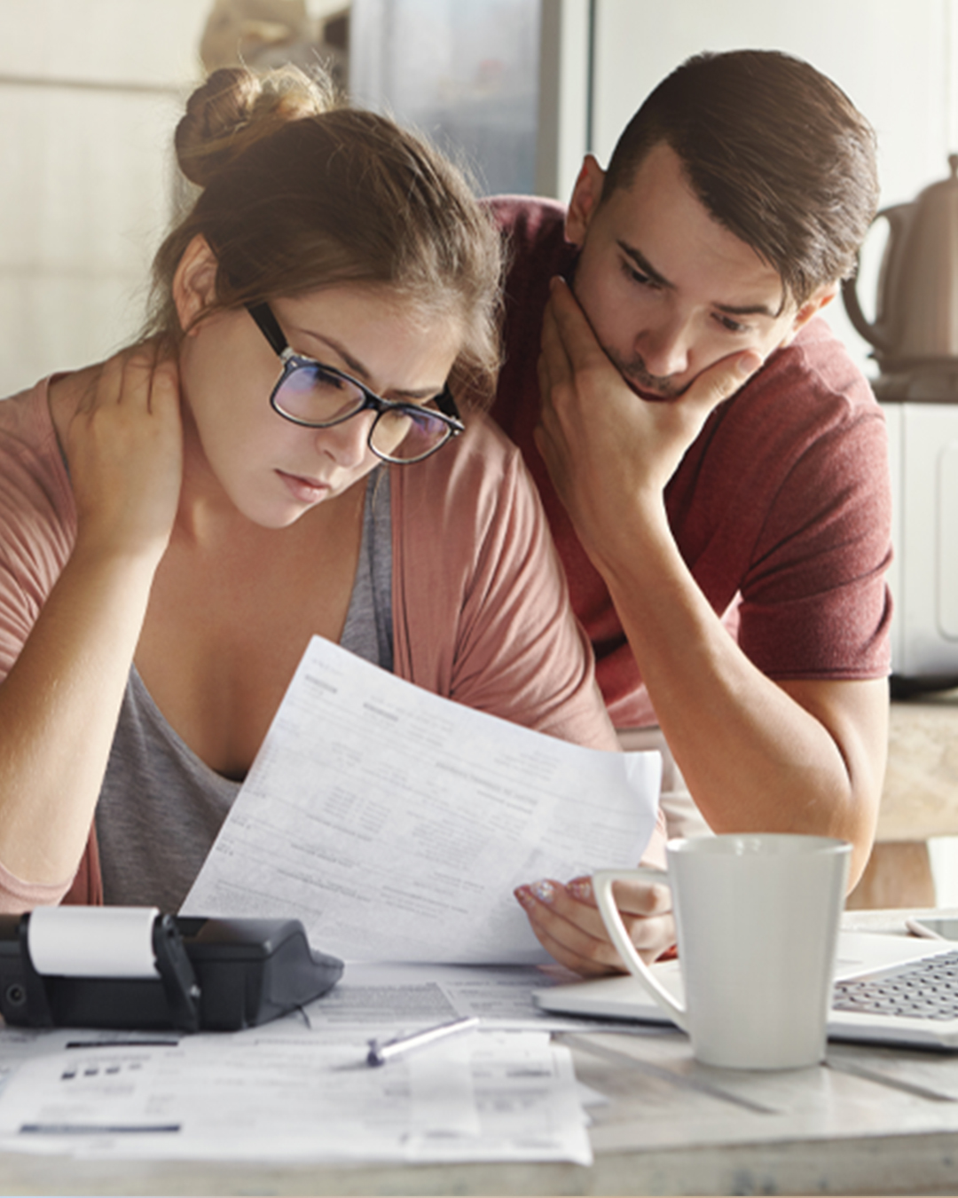 Two people look at paper with concern