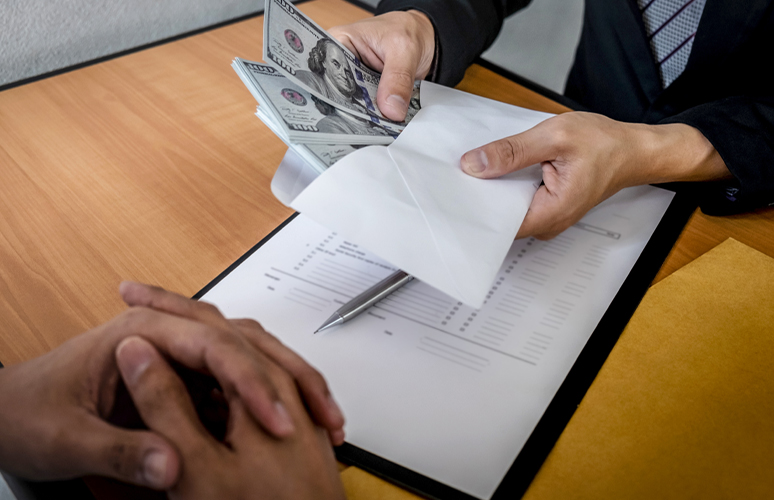 People exchanging an envelope of money