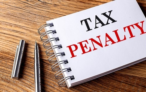 Tax penalty written on pad