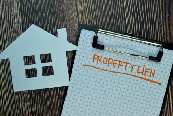 Property lien written on paper and house cutout