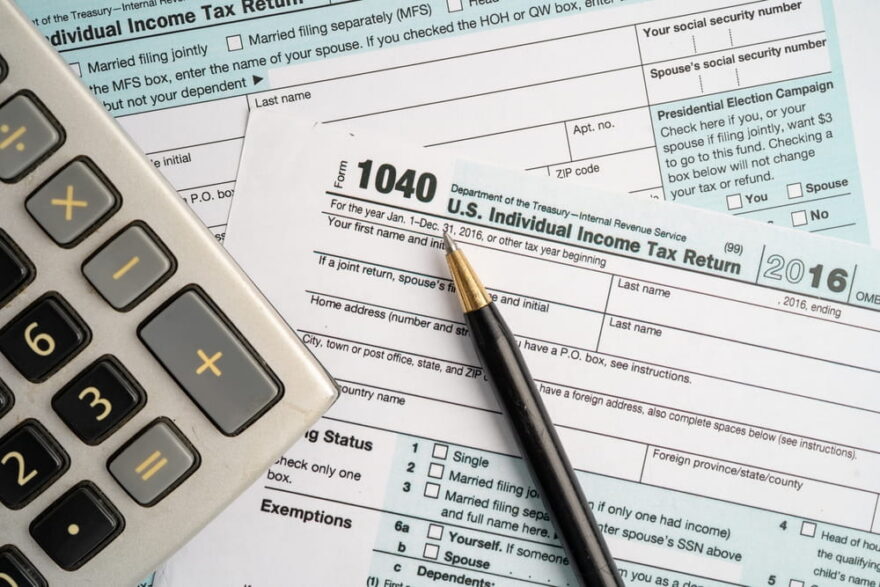 Blank or unfiled tax return with pen and calculator