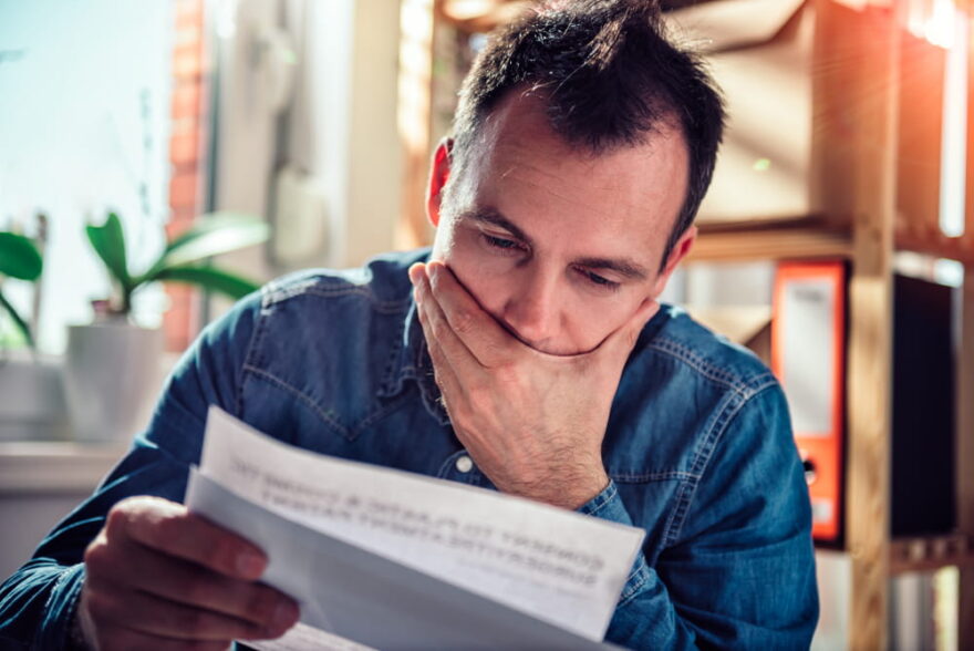 man looking at IRS SFR letter