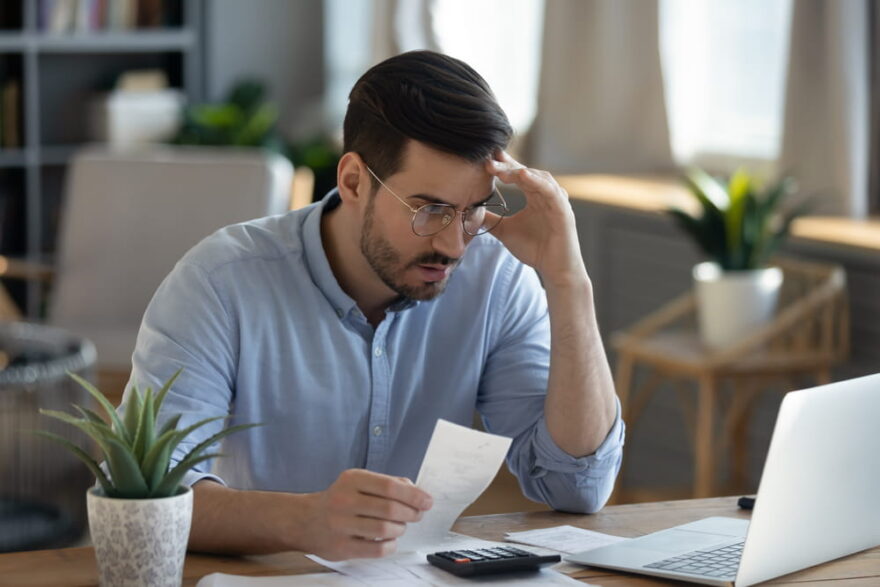 man sitting at desk looking at IRS notice