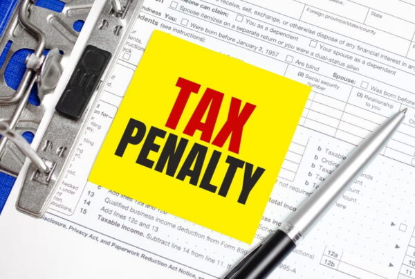 tax penalty written on pad with tax return