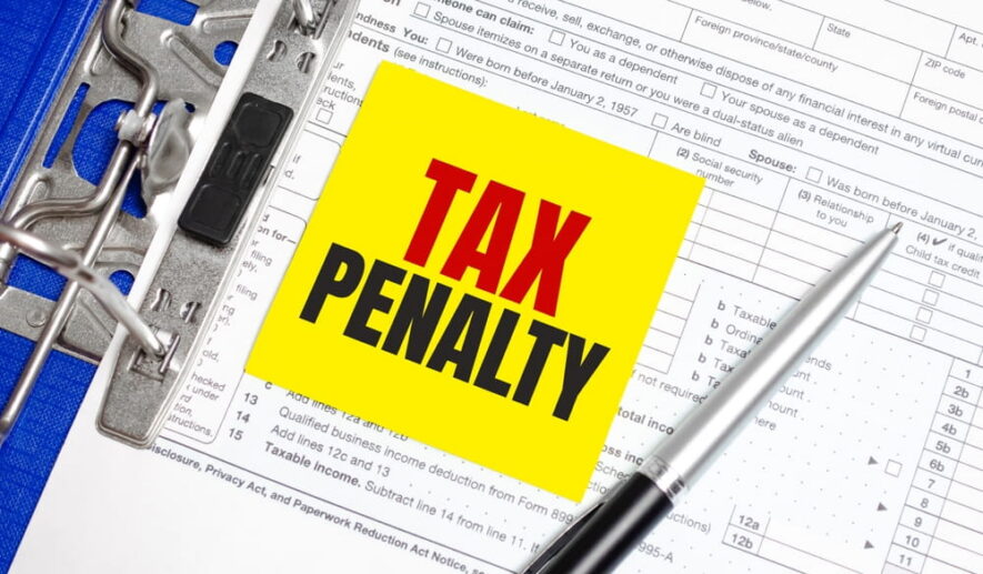 tax penalty written on pad with tax return